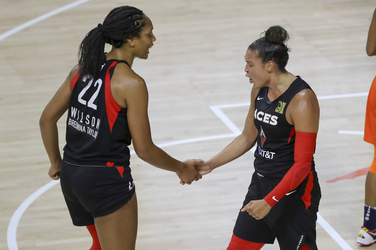 Las Vegas Aces' Kayla McBride, right, celebrates with A'ja Wilson after a basket against the Co ...