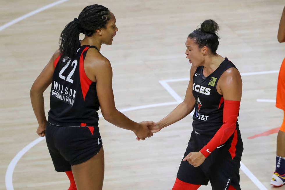Las Vegas Aces' Kayla McBride, right, celebrates with A'ja Wilson after a basket against the Co ...