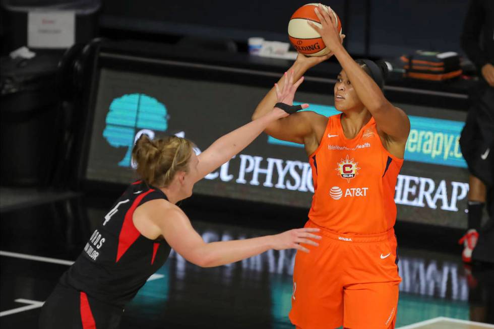 Connecticut Sun's Brionna Jones, right, shoots over Las Vegas Aces' Carolyn Swords during the f ...