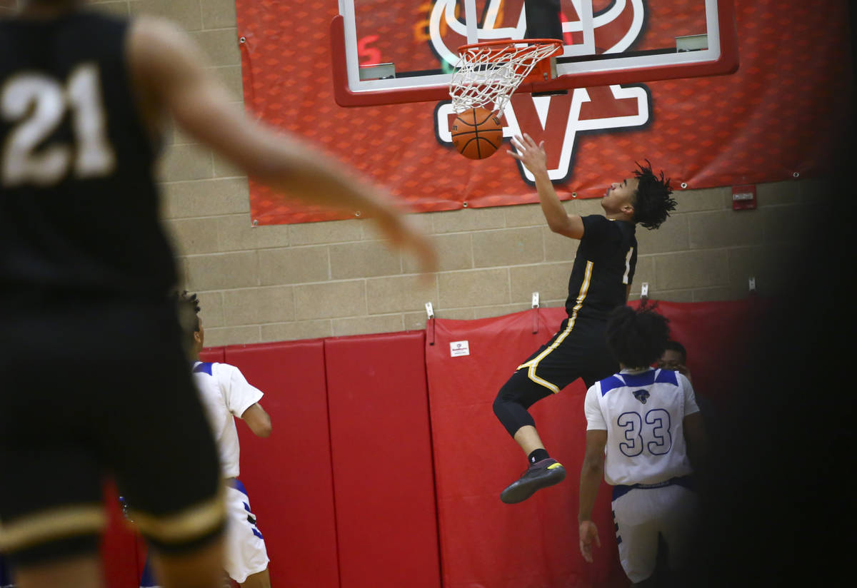 Clark's Frankie Collins (1) dunks against Desert Pines during the first half of a Class 4A stat ...