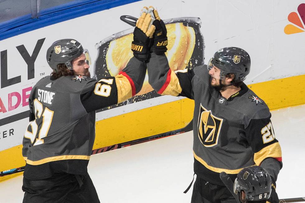 Vegas Golden Knights' Mark Stone (61) and Shea Theodore (27) celebrate a goal against the Chica ...