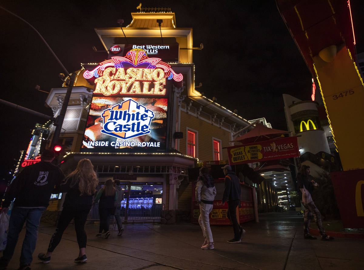 People walk past Casino Royale on the Strip on Tuesday, March 17, 2020, in Las Vegas. (Ellen Sc ...