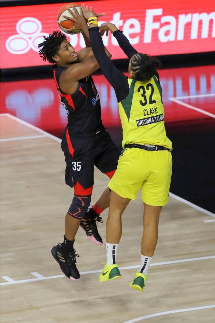 Las Vegas Aces' Angel McCoughtry (35) shoots against Seattle Storm's Alysha Clark during the fi ...