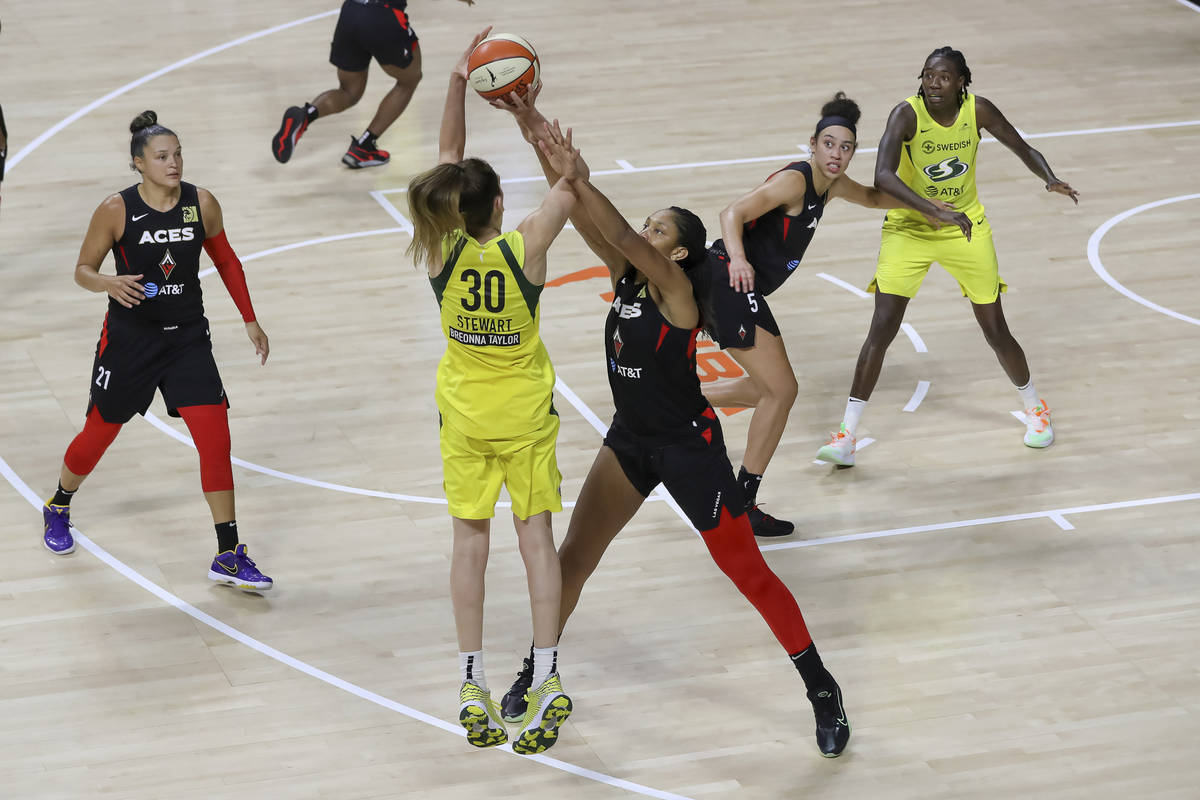 Seattle Storm's Breanna Stewart (30) has her shot disrupted by Las Vegas Aces' A'ja Wilson duri ...