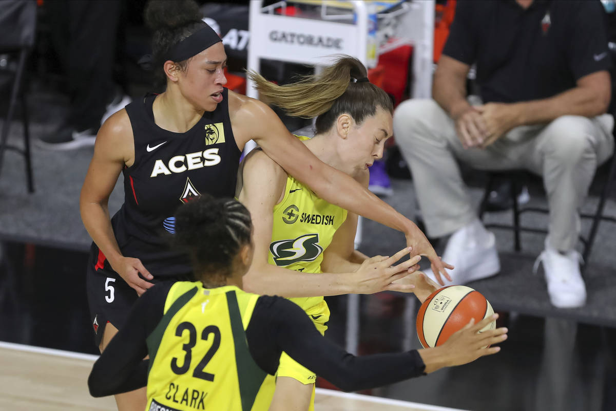 Las Vegas Aces' Dearica Hamby (5) defends against Seattle Storm's Breanna Stewart during the fi ...