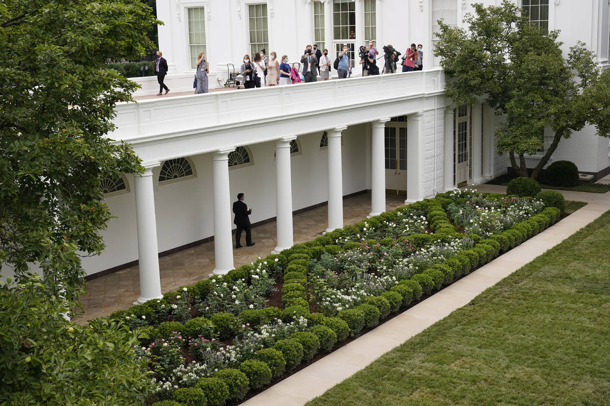 Journalists get an overhead view of the restored Rose Garden at the White House in Washington, ...