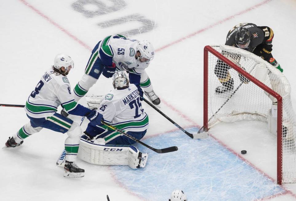 Vegas Golden Knights' Jonathan Marchessault (81) scores on Vancouver Canucks goalie Jacob Marks ...