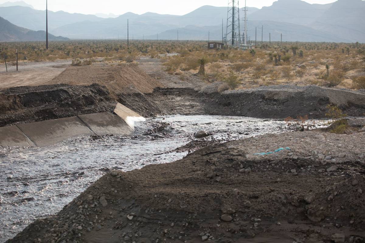 Water drains on the side of southbound U.S. 95 near Mt. Charleston north of Las Vegas, Sunday, ...