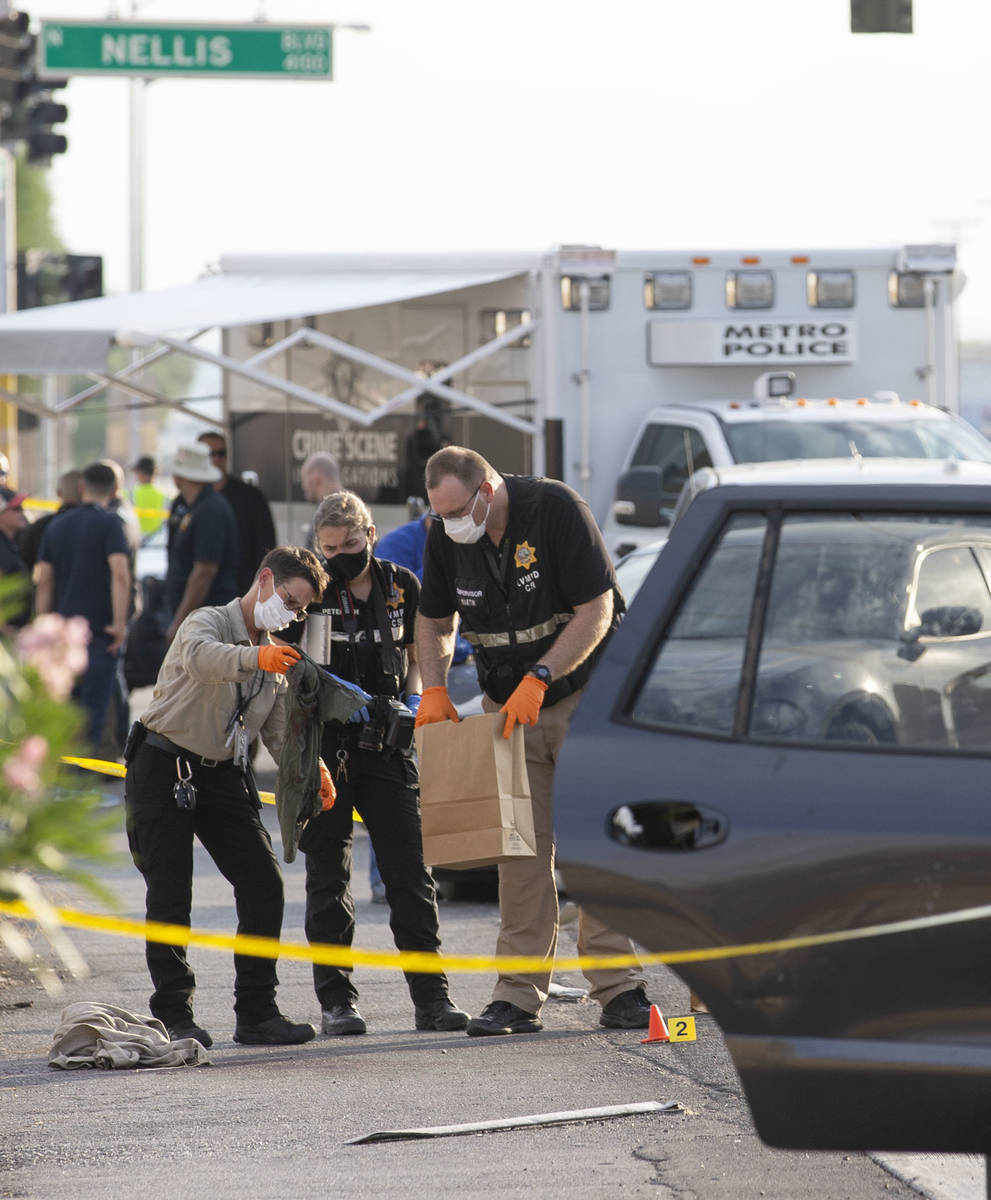 Metropolitan police collect evidence while investigating the homicide of a juvenile near the in ...