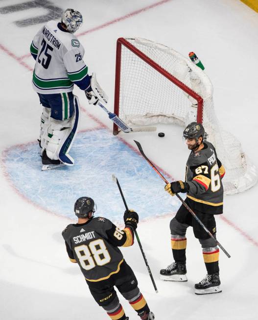 Vegas Golden Knights' Nate Schmidt (88) and Max Pacioretty (67) celebrate a goal on Vancouver C ...