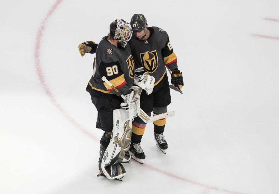 Vegas Golden Knights goalie Robin Lehner (90) and teammate Max Pacioretty (67) celebrate a win ...