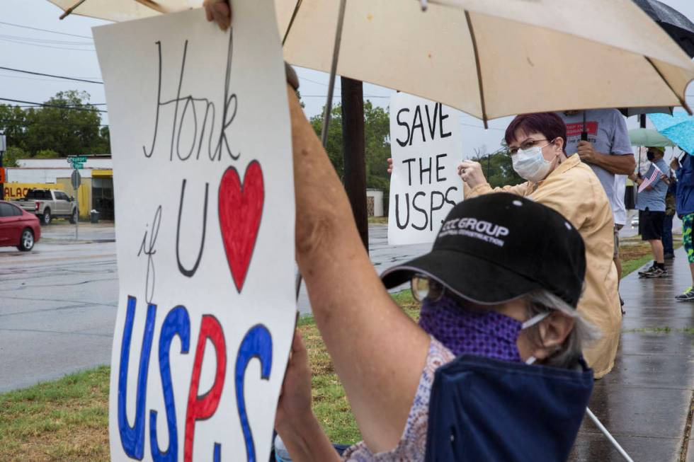 Robin Schriefer and Sue King rally in support of the U.S. Postal Service outside the post offic ...