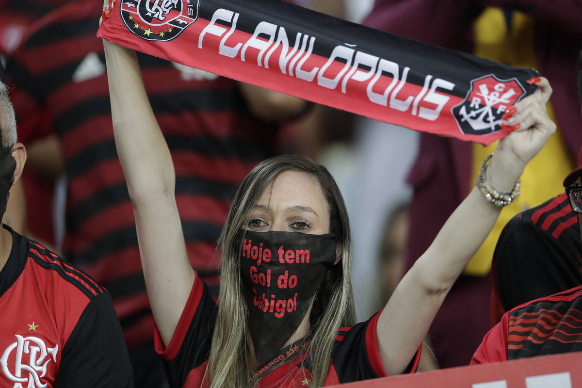 A fan of Brazil's Flamengo uses a mask before a Copa Libertadores soccer match against Ecuador' ...