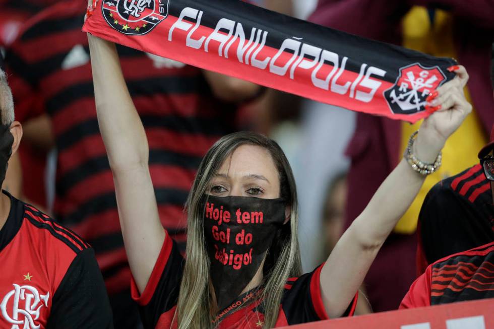 A fan of Brazil's Flamengo uses a mask before a Copa Libertadores soccer match against Ecuador' ...