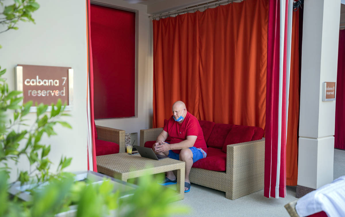 Jonathan Taylor of California works remotely in a cabana at Red Rock resort-casino on Wednesday ...