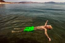 Lucas School, 10, of Glenwood Springs, Colo., floats at Boulder Beach while joining family abou ...