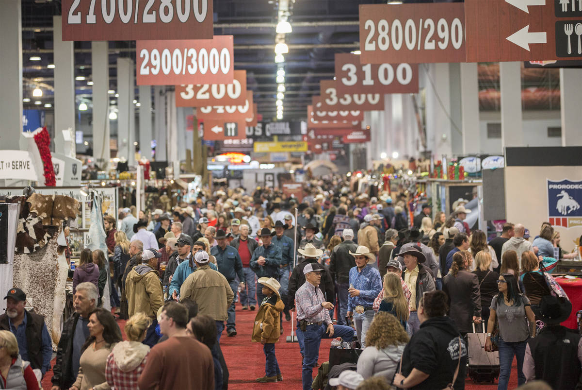 Shoppers walk the South Halls during Cowboy Christmas at the Las Vegas Convention Center on Thu ...