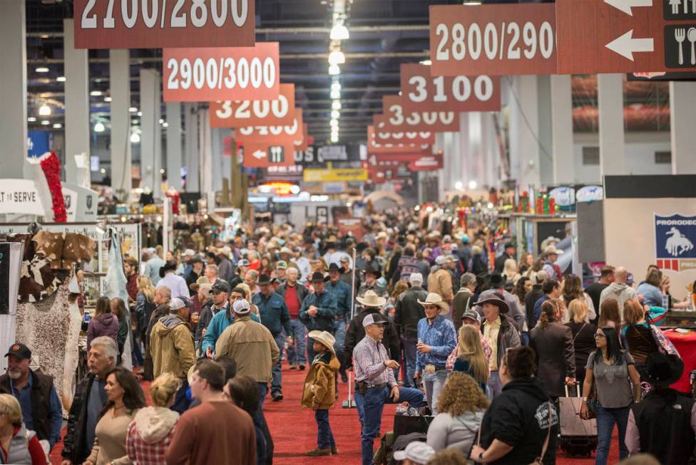 Shoppers walk the South Halls during Cowboy Christmas at the Las Vegas Convention Center on Thu ...