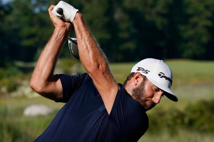 Dustin Johnson tees off on the 13th hole during the final round of the Northern Trust golf tour ...