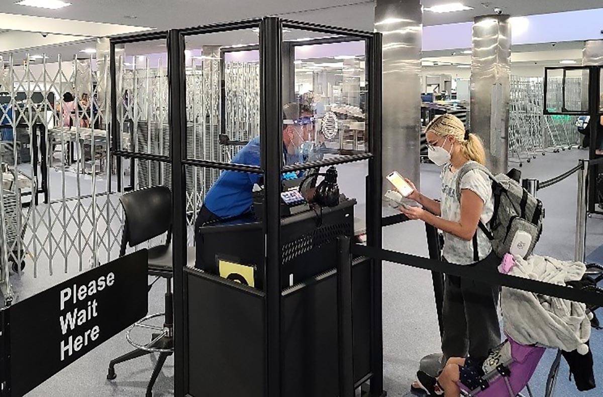 Acrylic barriers have been installed in security checkpoints at McCarran International Airport ...