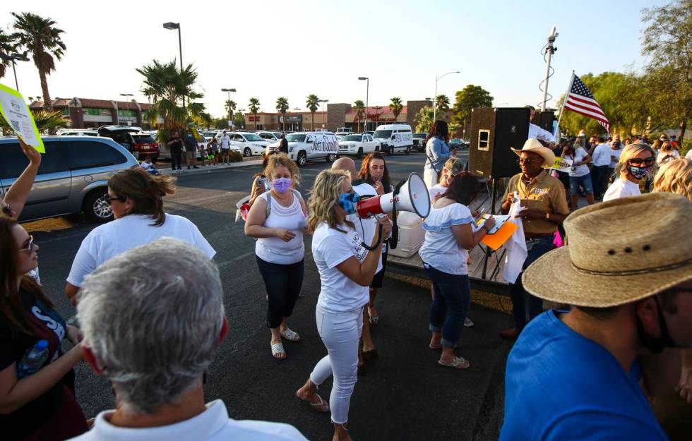 Erin Phillips, president of Power2Parent, speaks during a demonstration in support of reopening ...