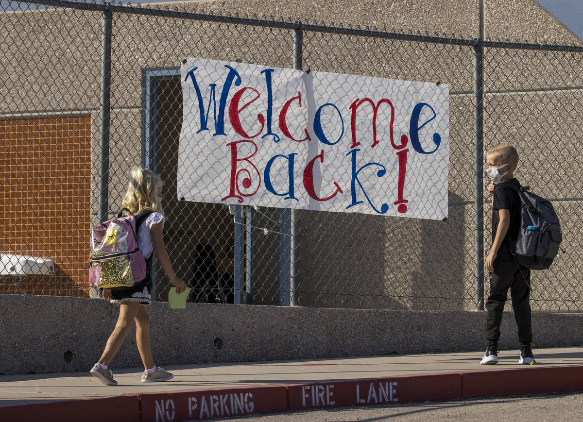 A sign signals the opening day of class for students at Ute Perkins Elementary School having be ...