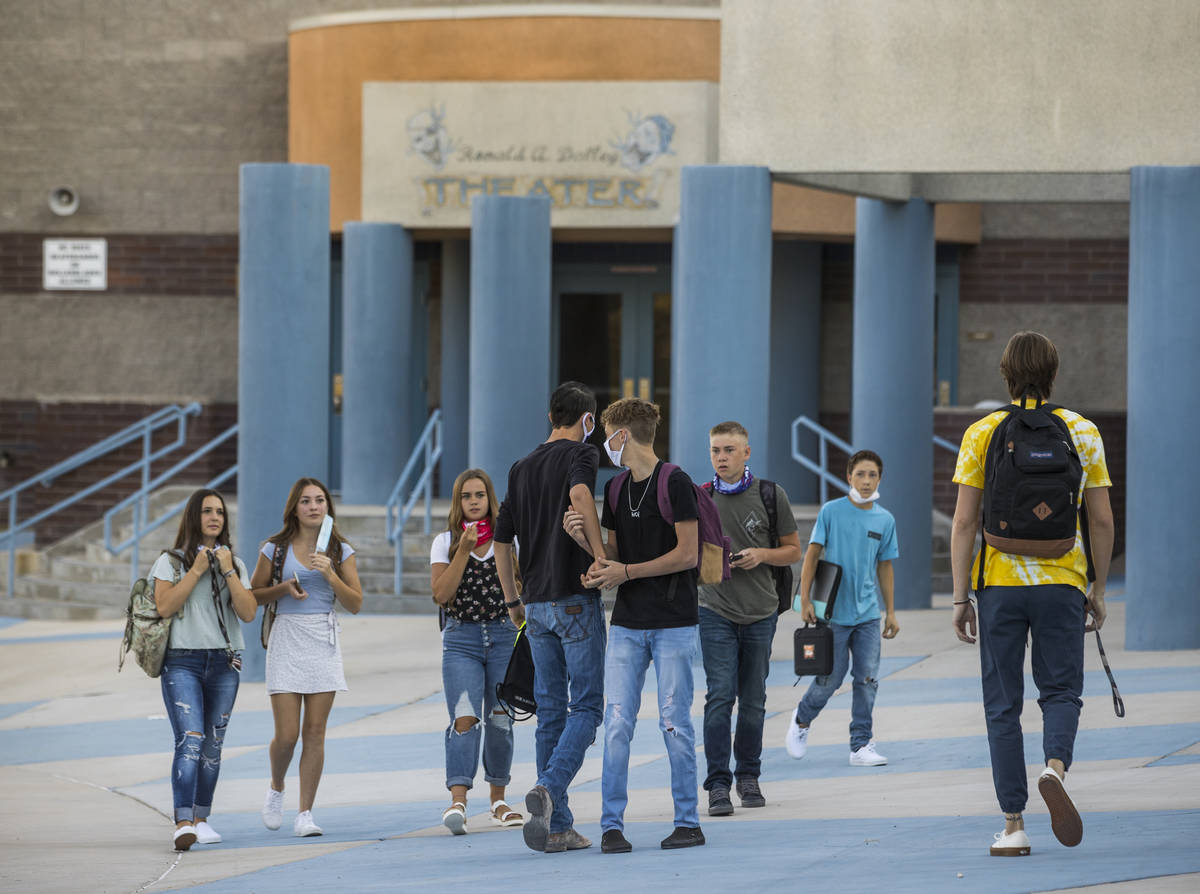 Students greet each other outside at Moapa Valley High School before the start of classes with ...