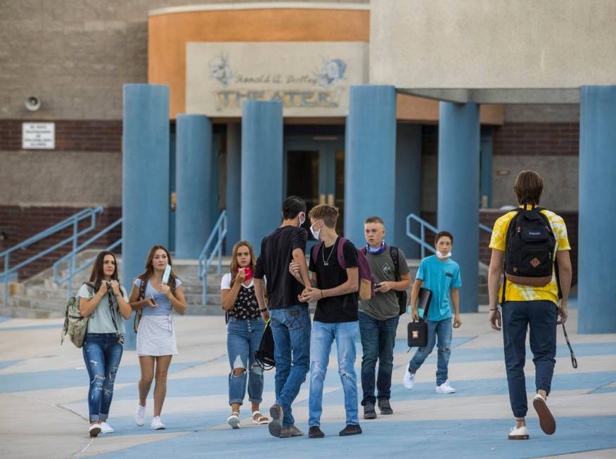 Students greet each other outside at Moapa Valley High School before the start of classes with ...