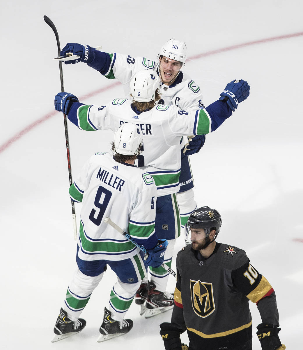 Vegas Golden Knights' Nicolas Roy (10) skates past as Vancouver Canucks' Bo Horvat (53), Brock ...