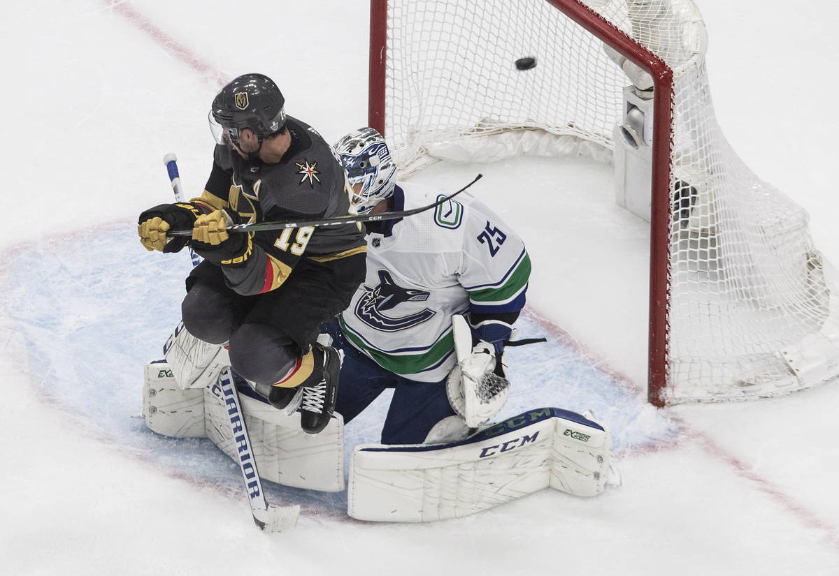 Vegas Golden Knights' Reilly Smith (19) jumps as the puck goes past Vancouver Canucks goalie Ja ...