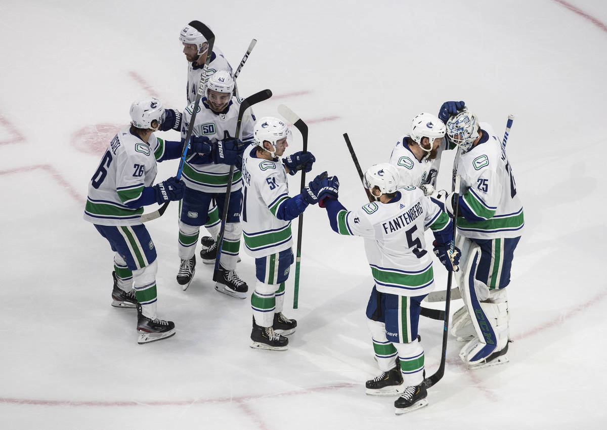 Vancouver Canucks celebrate the team's win over the Vegas Golden Knights during Game 2 of an NH ...