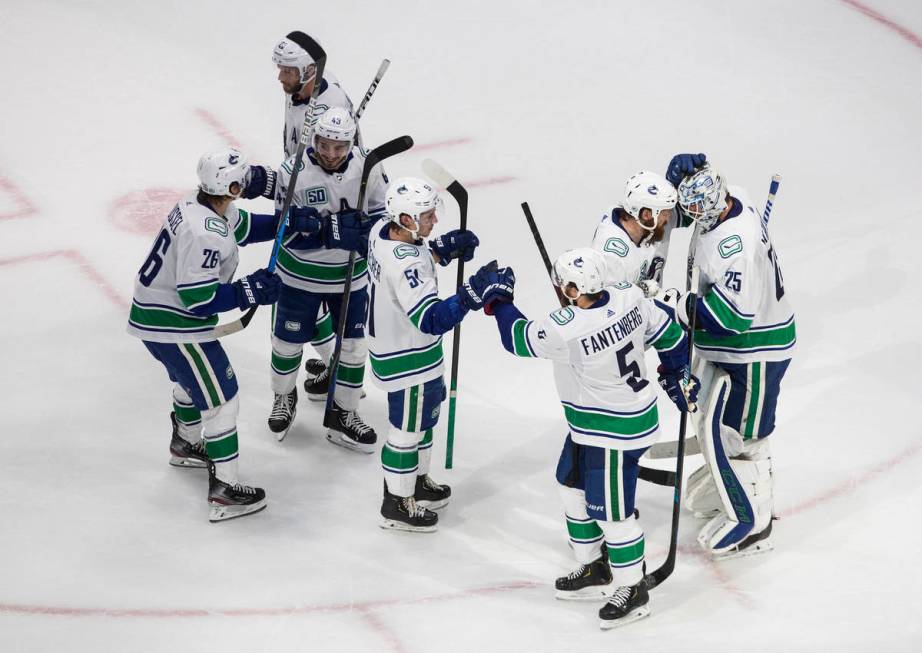 Vancouver Canucks celebrate the team's win over the Vegas Golden Knights during Game 2 of an NH ...