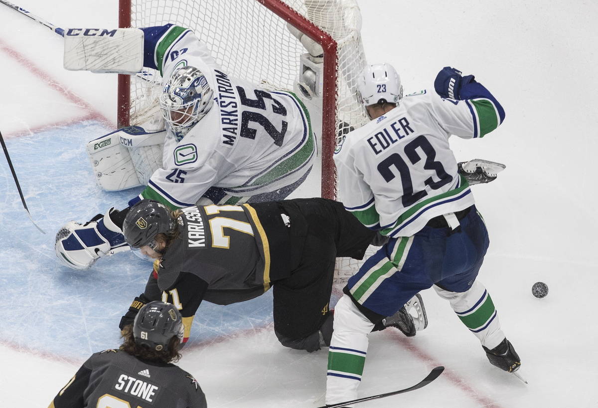 Vegas Golden Knights' William Karlsson (71) is stopped by Vancouver Canucks goalie Jacob Markst ...