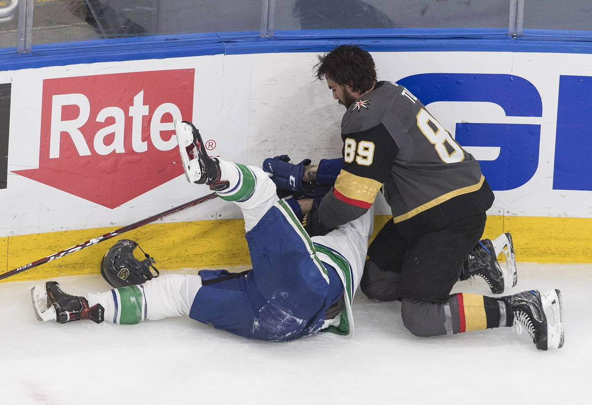 Vegas Golden Knights' Alex Tuch (89) fights Vancouver Canucks' Jake Virtanen (18) during the th ...