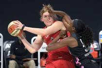 Las Vegas Aces center Carolyn Swords, left, is guarded by Dallas Wings center Astou Ndour, righ ...
