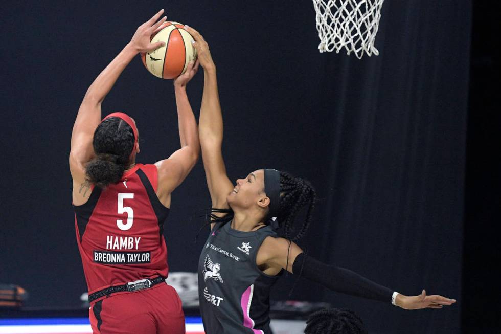 Dallas Wings forward Satou Sabally, right, blocks a shot by Las Vegas Aces forward Dearica Hamb ...