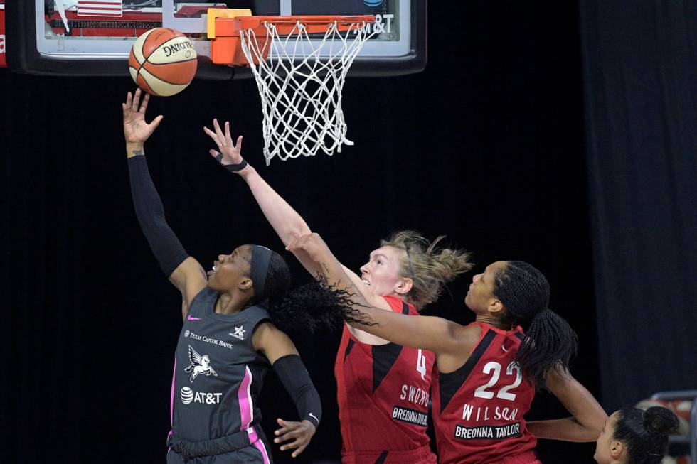 Dallas Wings guard Arike Ogunbowale (24) goes up for a shot in front of Las Vegas Aces center C ...