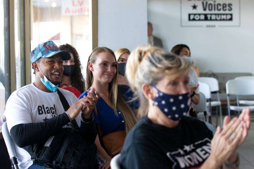 Michael "Little Mike" Armstrong Jr., left, and Rae-Ann Armstrong, center, clap after ...