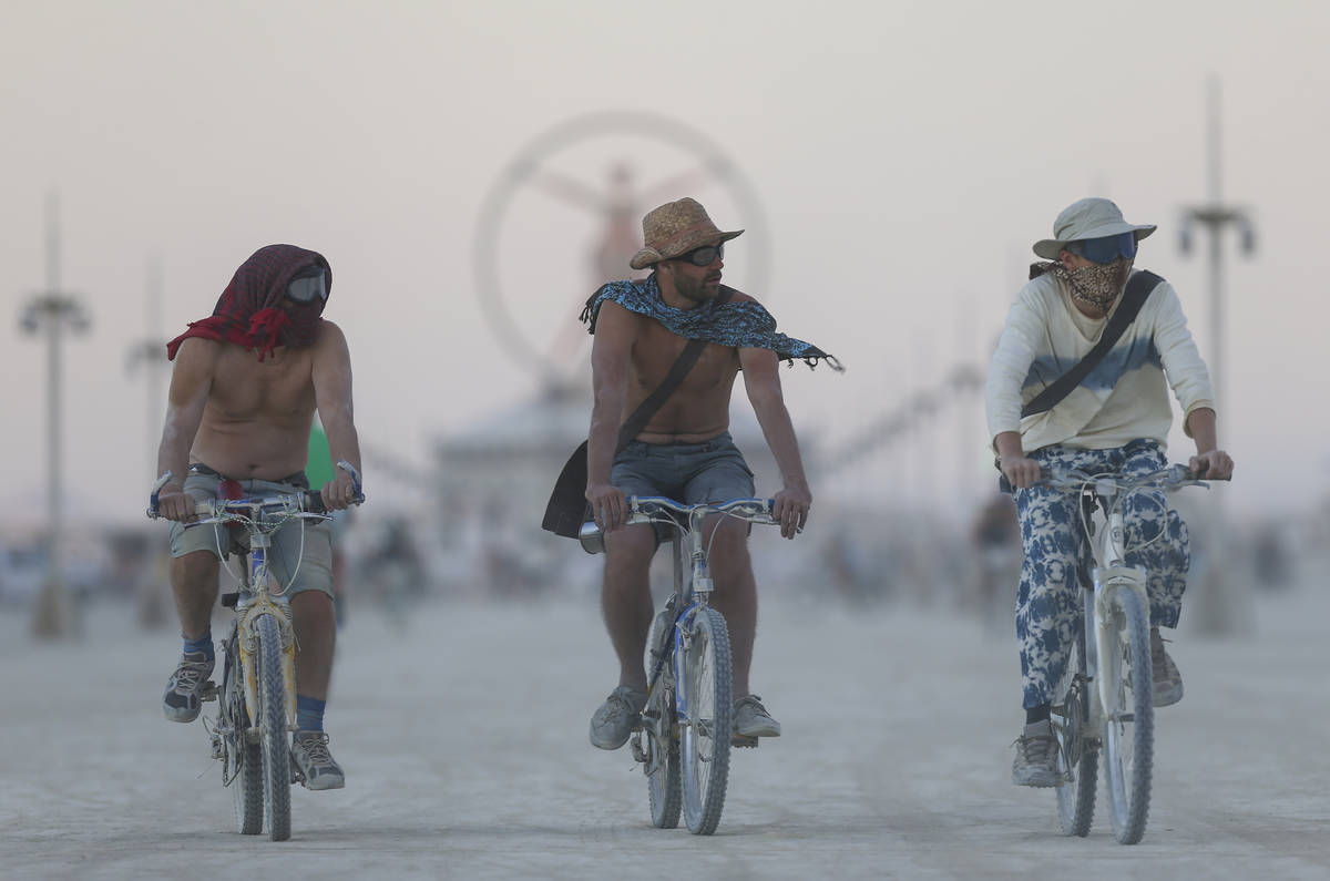 Attendees ride bikes on the playa during Burning Man at the Black Rock Desert north of Reno, Au ...