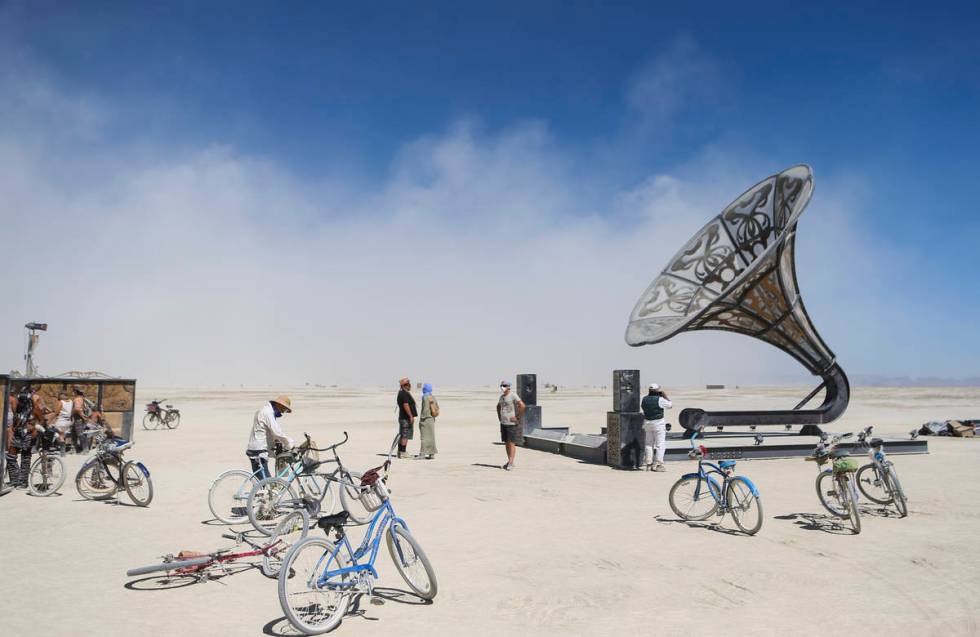Attendees take in an art installation during Burning Man at the Black Rock Desert north of Reno ...