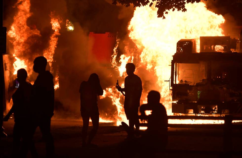 Garbage and dump trucks were set ablaze on Sunday, Aug. 23, 2020 by rioters near the Kenosha Co ...