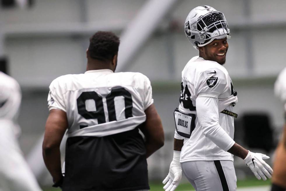 Las Vegas Raiders defensive end Arden Key warms up with teammates during an NFL training camp p ...