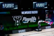 Milwaukee Bucks signage is displayed on screens beside an empty court before the scheduled star ...
