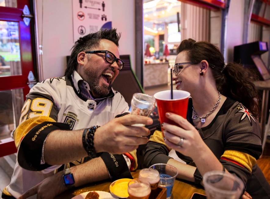 Will and Jenny Ayces, from Anaheim, Calif., celebrate during the Golden Knights NHL playoff hoc ...