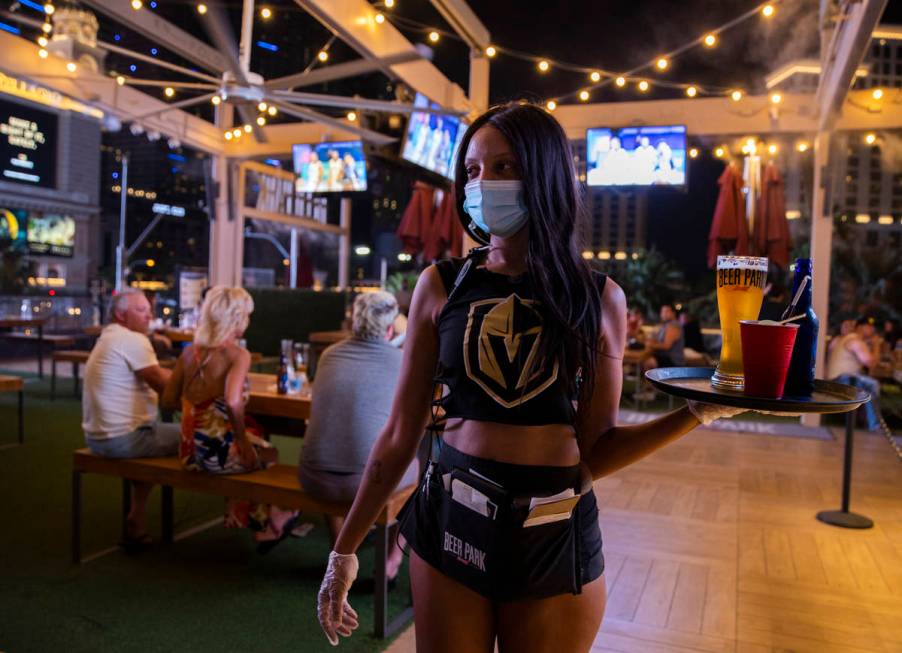 Server Crystal Clay wears Golden Knights attire while working at Beer Park during VegasÕ N ...