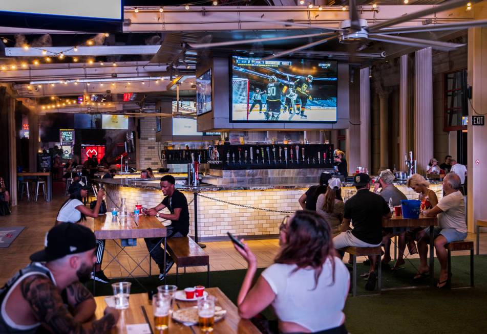 Hockey fans watch the Golden Knights play the Vancouver Canucks during an NHL playoff hockey ga ...