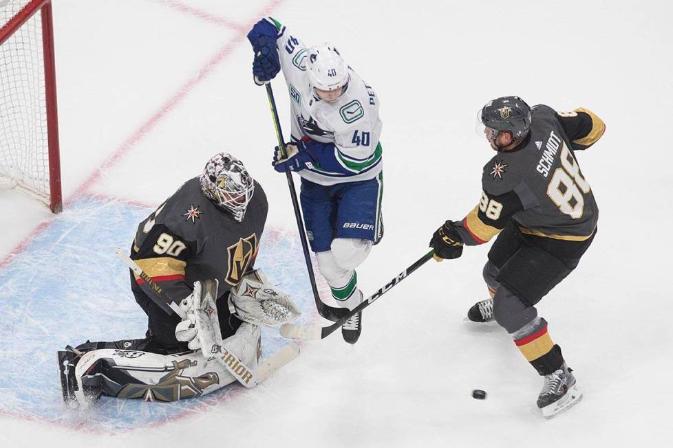 Vegas Golden Knights' goalie Robin Lehner (90) makes the save as Vancouver Canucks Elias Petter ...