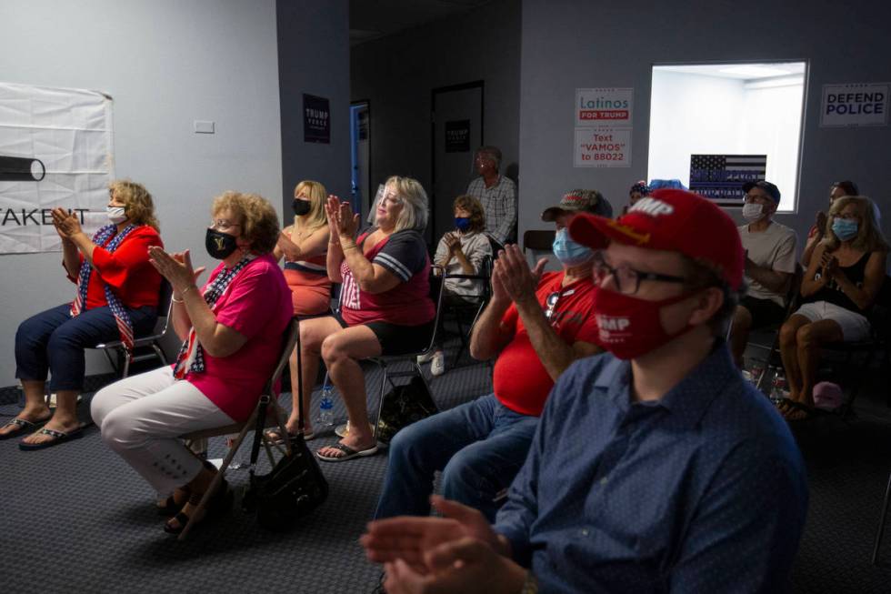 Attendees of a watch party for the Republican National Convention clap following a speech from ...