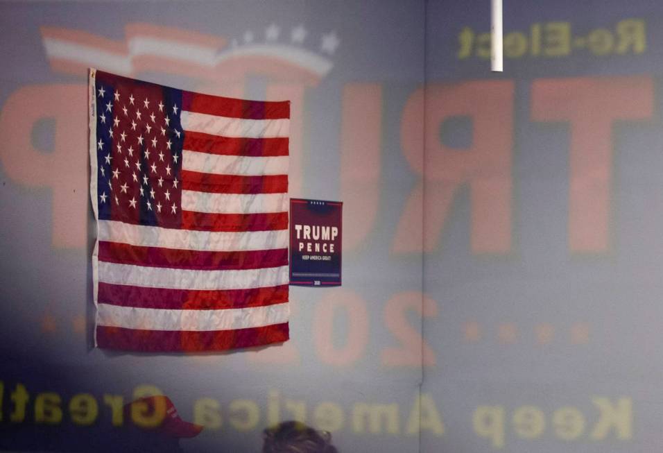 An American Flag and Trump campaign signs adorn the walls at the Trump campaign office in Hende ...