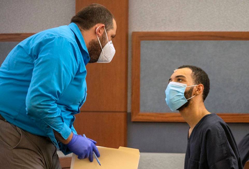 Attorney Damian Sheets, left, speaks to Cameron Hubbard-Jones, in the courtroom of Las Vegas Ju ...